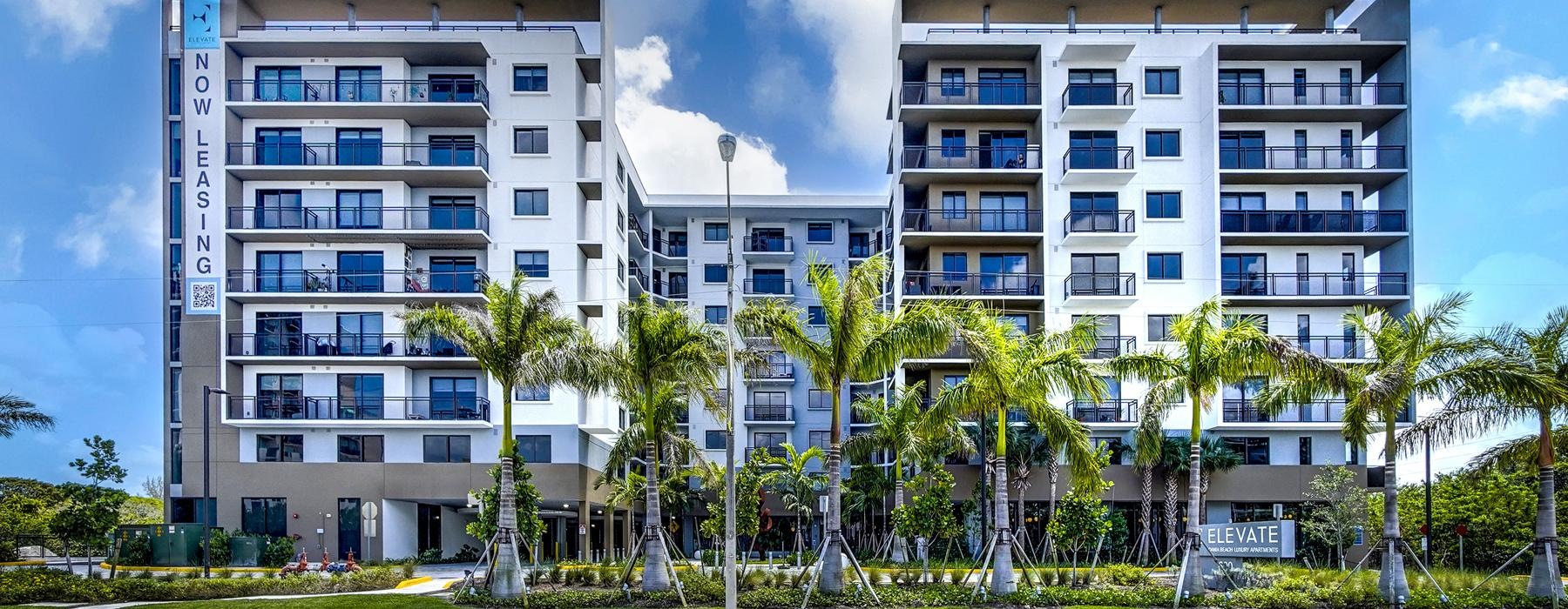 a building with palm trees in front of it