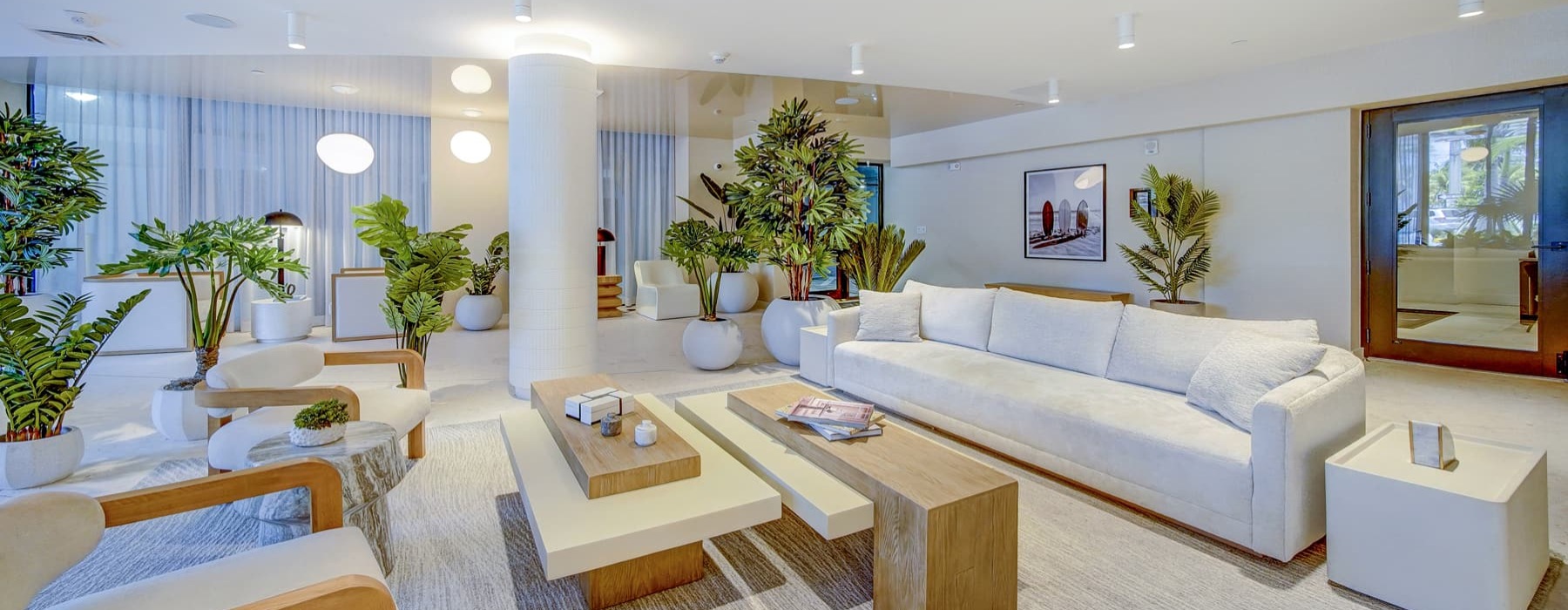 lounge area with long white couches and ample lighting