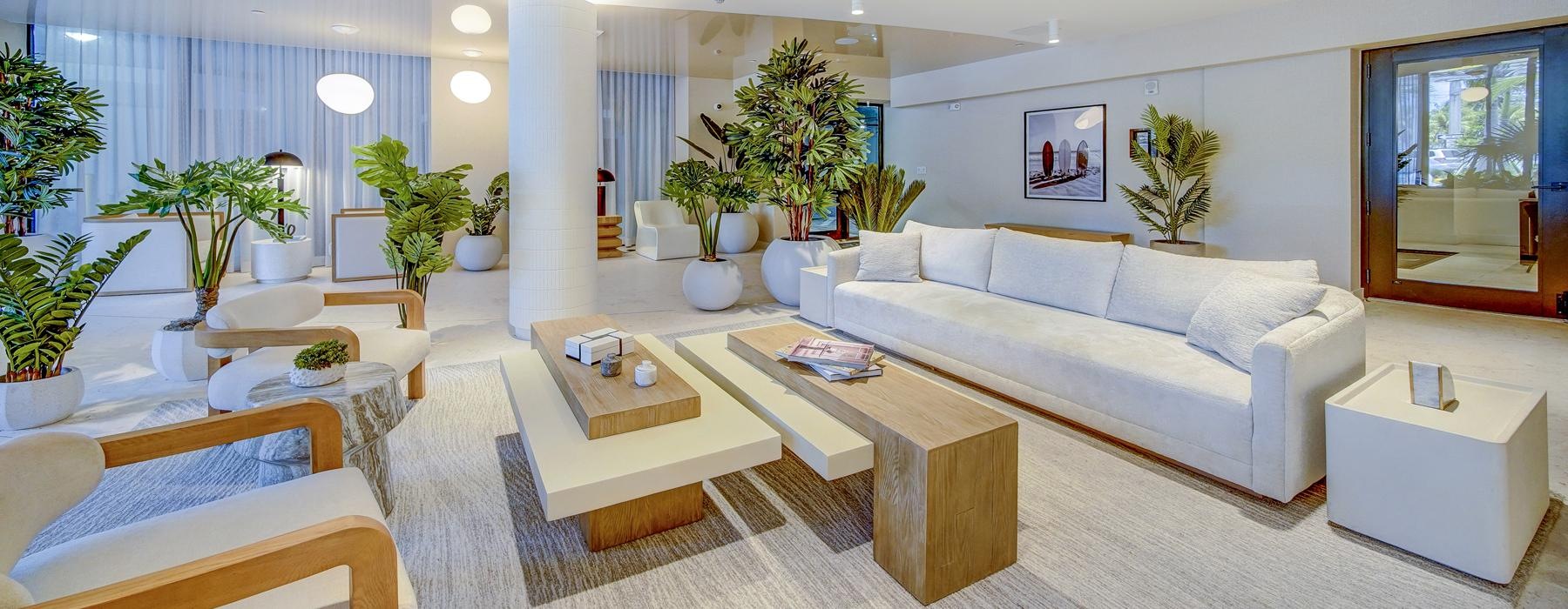 lounge area with long white couches and ample lighting