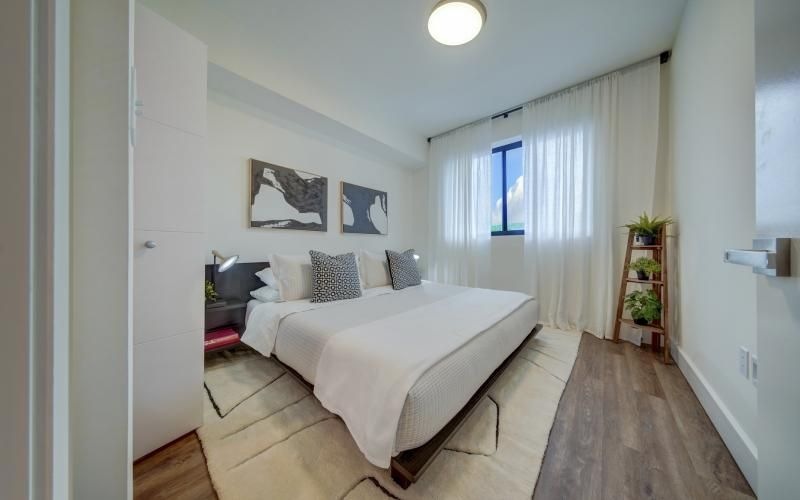 a bedroom with a bed and a window