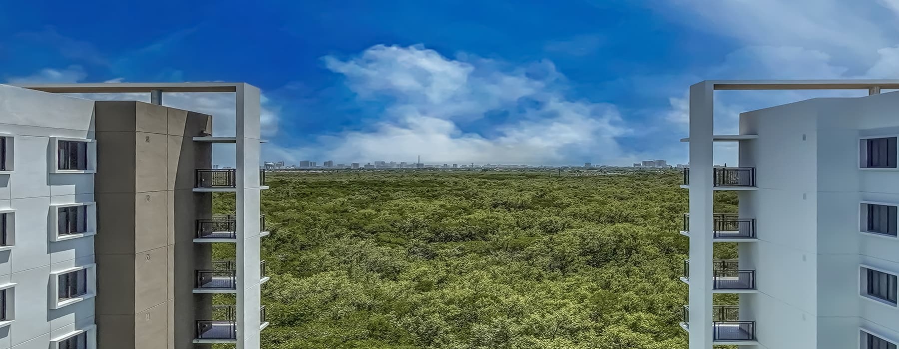 two high rise buildings with ample nature nearby